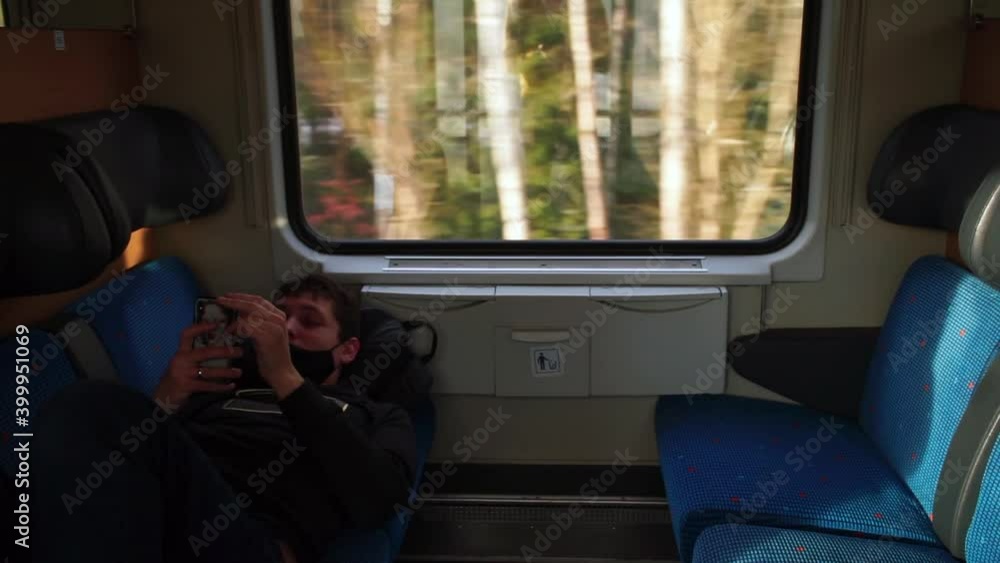 Poster communication of a person on a journey train. using the mobile application. the man uses a mobile ph