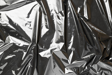 Plastic bag. Wrap transparent dark cellophane texture. Black shiny film pattern. Creative crumpled...