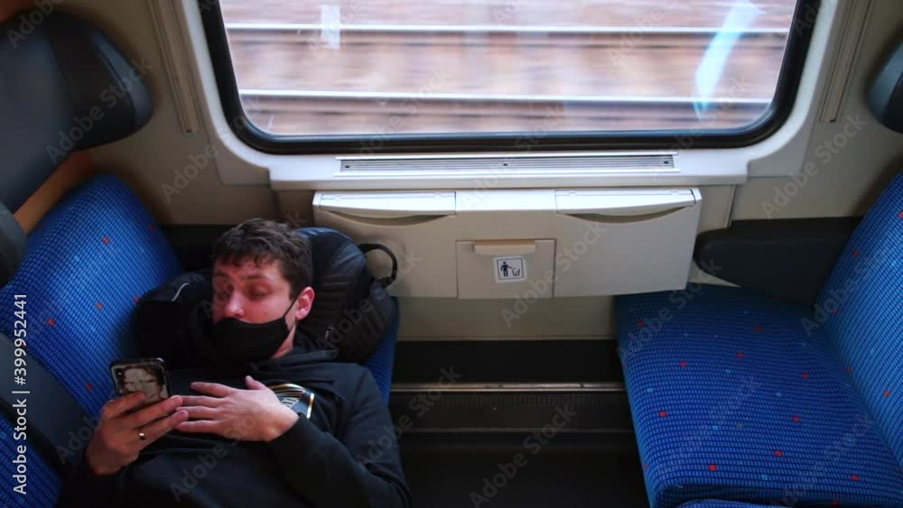 Poster using mobile application. reading an e-book. man uses cell phone. it lies in passenger seat near win