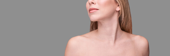 Cosmetology concept. Skin care product. Female portrait. Face mask. Home peeling. Grey background. Copyspace. Facial lifting treatment. Dermatology beauty model. Neck - obrazy, fototapety, plakaty