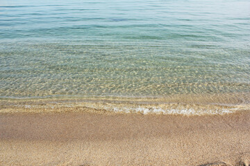 Fototapeta na wymiar Soft beautiful ocean wave on sandy beach. Background