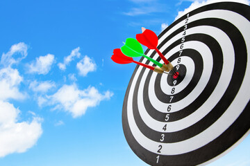Close up shot of the dart arrow hit on bullseye, red dart arrow hitting in the target center of...