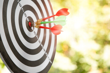 Close up shot of the dart arrow hit on bullseye, red dart arrow hitting in the target center of...