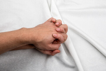 Hands of two lovers. Man and woman, passion and making love concept. White fabric background