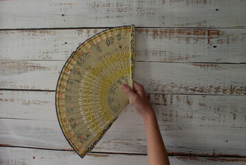 woman's hand holding spanish fan
