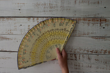 woman's hand holding spanish fan