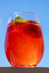 Summer refreshing cocktail with strawberries, ice and fresh mint leaves.