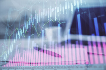 Double exposure of financial graph drawings and desk with open notebook background. Concept of forex market