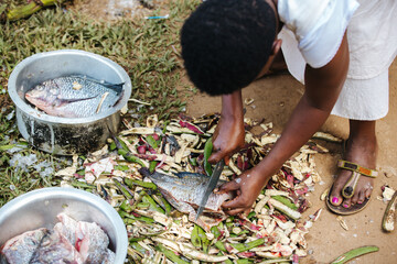 woman preparing fish in Uganda, Africa