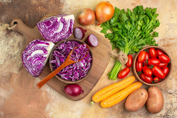 top view fresh and healthy vegetables for homemade salad on a wooden background with free space for text