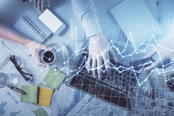 Double exposure of man and woman working together and forex graph hologram drawing. Financial analysis concept. Computer background. Top View.