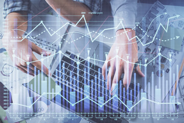 Double exposure of man and woman working together and forex graph hologram drawing. Financial analysis concept. Computer background. Top View.
