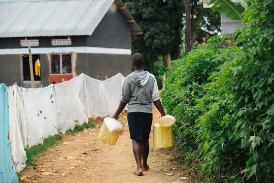 Woman carrying water in Uganda, Africa