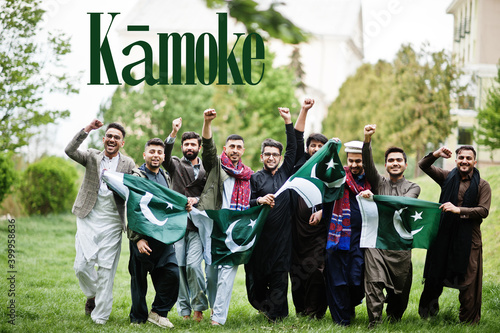 Kamoke city. Group of pakistani man wearing traditional clothes with national flags. Biggest cities of Pakistan concept.