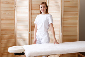 masseur near the table for massage