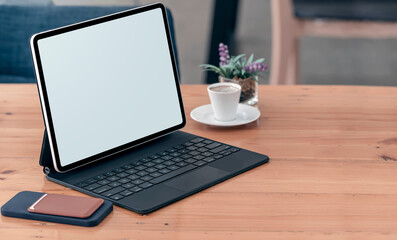 Fototapeta premium Mockup blank screen tablet with keyboard on wooden table.