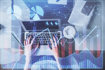 Double exposure of woman hands working on computer and forex chart hologram drawing. Top View. Financial analysis concept.