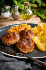 Meatballs  served with fired potatoes.