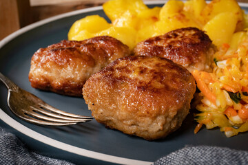 Meatballs  served with fired potatoes.