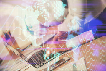 Multi exposure of woman hands typing on computer and financial chart hologram drawing. Stock market...