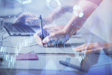 Multi exposure of woman hands typing on computer and financial chart hologram drawing. Stock market analysis concept.