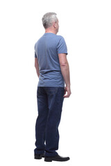 Fototapeta premium Back view of a man in t-shirt and jeans looking away
