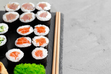 Maki sushi set served on black stone tray
