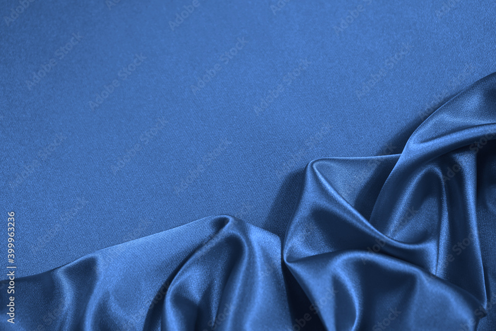 Wall mural blue silk satin fabric background. copy space for your design. delicate wavy folds. beautiful elegan
