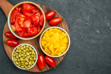 top close view of vegetables on plate stand with free space for your text on dark grey background