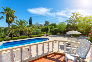 View from the terrace to the luxury pool with clear water in the garden. For tourists.