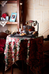 A table in a vintage cafe with a glass of alternatively prepared coffee, cookies and a vintage telephone