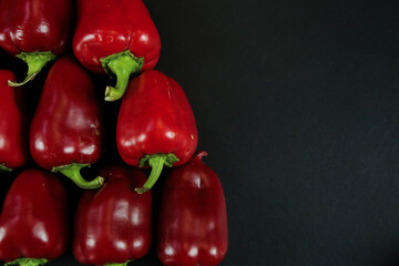 Red peppers on black background