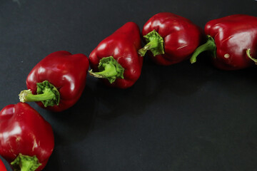 Red peppers on black background