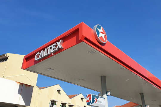 Caltex gas station signs against the blue sky background. Caltex is a petroleum brand name of Chevron Corporation used in more than 60 countries. PENANG, MALAYSIA - JULY 30, 2020.