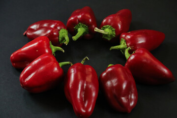 Red peppers on black background