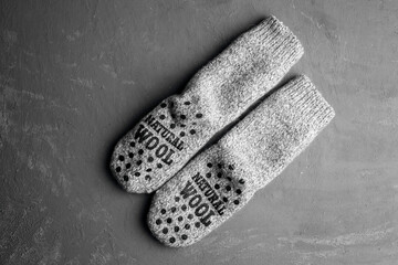 
Knitted socks on a gray background, flat lay. Place for text