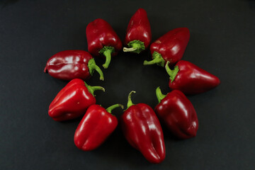 Red peppers on black background