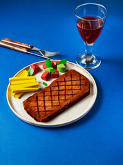 Colorful but tasteless food made of carton on blue background