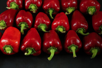Red peppers on black background
