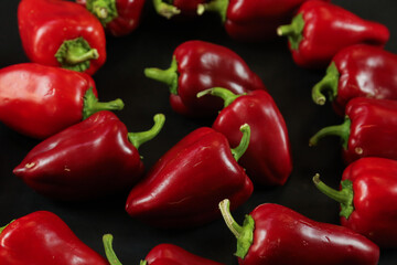 Red peppers on black background