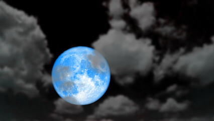 Super cold blue moon rise back blur dark cloud on the night sky