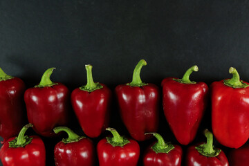 Red peppers on black background