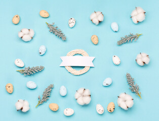 Craft Easter eggs on blue pastel background, space for text. Flat lay image composition, top view.