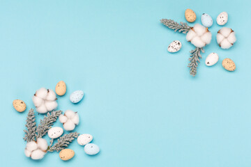 Craft Easter eggs on blue pastel background, space for text. Flat lay image composition, top view.