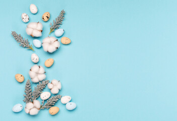 Craft Easter eggs on blue pastel background, space for text. Flat lay image composition, top view.