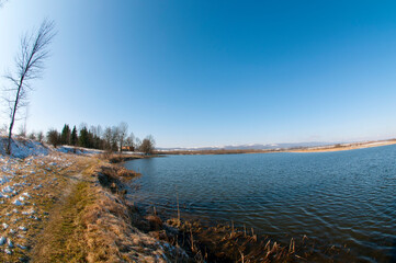winter on the shore of a frozen lake on a sunny day
