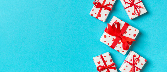 Top view of gift boxes with red hearts on colorful background. St Valentine's day concept with copy space