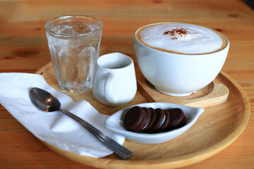 Cup of coffee with biscuits on table