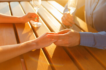 Happy couple drinks champagne on a yacht