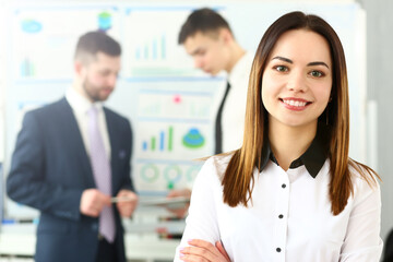 Portrait of beutiful female working on intense business project. Smart woman discussing questionable subject with witty colleagues. Company meeting concept